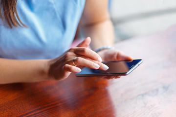 A young woman is using her smart phone