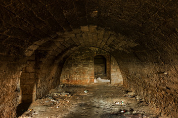 Fototapeta na wymiar Old abandoned tunnel in the underground wine cellar. Entrance to