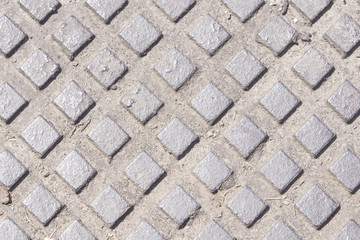 Old metal manhole texture with rectangles pattern, background macro, selective focus.
