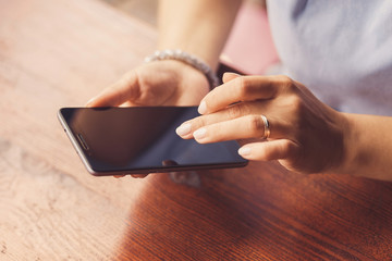 A woman is using her smart phone