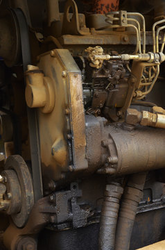 Old engine of grader car with oil engine leak