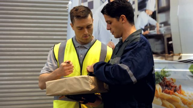 Man delivering courier to warehouse worker