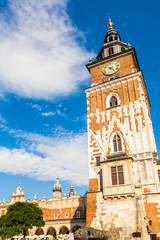 Fototapeta premium Beautiful high gothic town hall tower with clock in the main Market Square in Cracow, Poland. Travel Europe.