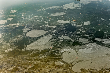 Dirty oil stains on the surface of the lake water polluted as a