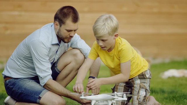 father and son study quadrocopter drone
