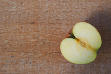 Top view of sliced apple on a wooden background.