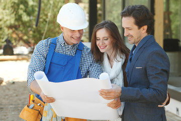 Worker shows house design plans