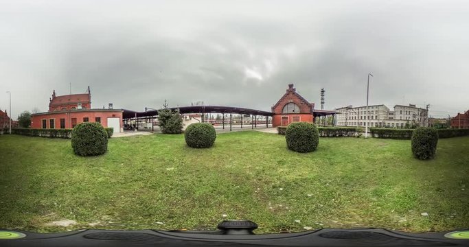 Lawn in Front of Railway Station Yard Video 360 vr Panoramic View of the Railroad Station Green Bushes Red Bricks Buildings and Cloudy Day Opole Poland