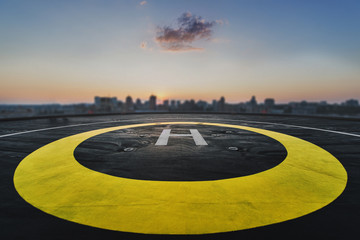 Helipad on the roof of a skyscraper with cityscape view