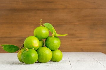 green lemon on white wooden
