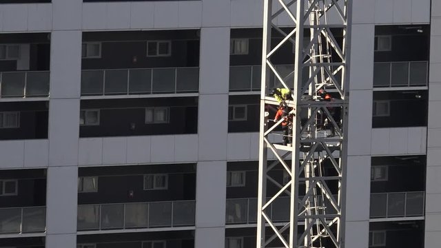 Builders assemble a tower crane. Sixty percent construction workers who died on the job were killed by falling from roofs, scaffolding or other high places.