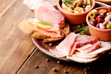 Tapas of salmon, mussels, jamon and olives