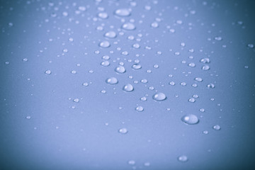 Drops of water on a color background. Blue. Shallow depth of fie