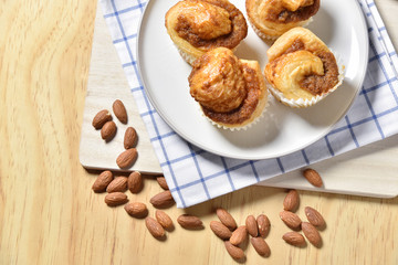 Almond danish cupcakes on wooden table.