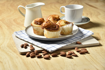 Almond danish cupcakes on wooden table.