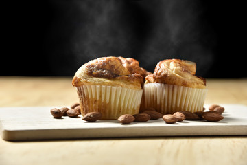 Almond danish cupcakes on wooden table.