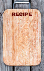 Top view of wooden cutting board on old  table