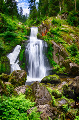 Fototapeta na wymiar Thundering and foaming waterfalls of Gutach in Germany, Triberg