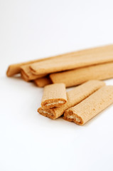 
Biscuit sticks with filling on white background