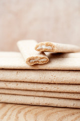 Biscuit sticks with filling on a wooden surface