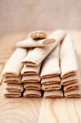 Biscuit sticks with filling on a wooden surface
