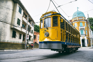 Fototapeta na wymiar Iconic bonde tram travels along the streets of the tourist nieghborhood of Santa Teresa in Rio de Janeiro, Brazil 