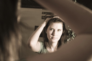 Fototapeta premium Woman looking in a mirror