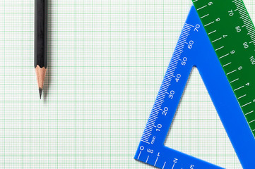 Pencil and Ruler on green graph paper with copy space