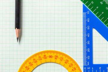 Pencil and Ruler on green graph paper with copy space