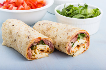 Wrap with tomato, lettuce, harissa and hoummous.