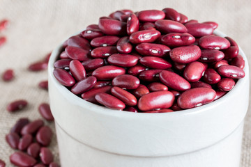 red kidney bean in white bowl on gunny