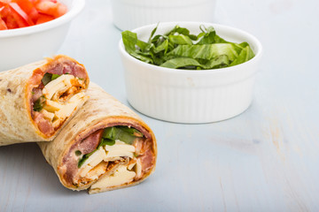 Wrap with tomato, lettuce, harissa and hoummous.