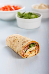 Wrap with tomato, lettuce, harissa and hoummous.