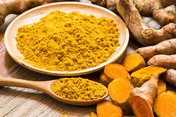 Fresh turmeric roots with turmeric powder