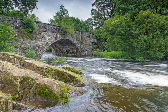 The River Brathay flows under Skelwith Bridge near Ambleside in the Lake District National Park, Cumbria, England a popular area for tourists.