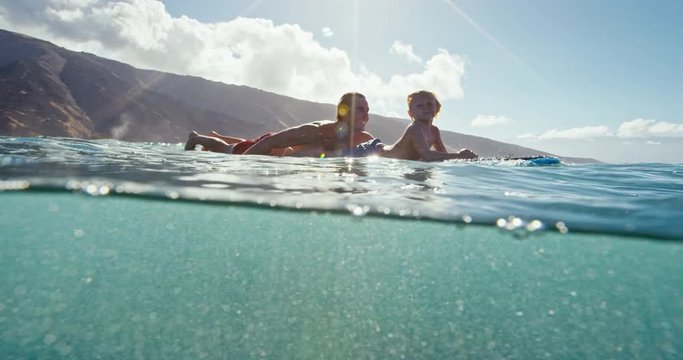 Father and son having fun surfing together, summer lifestyle family time