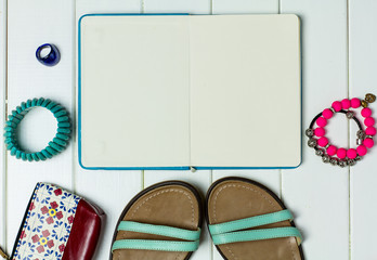 Sandals and accessories, set out for a walk on a white wooden background, mock up