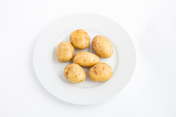 Potatoes on a plate white background
