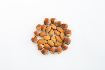 Almonds and hazelnuts on a white background