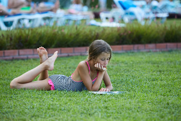 Girl are reading book at meadow