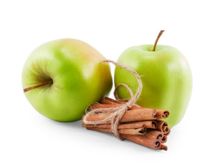 two green apples and cinnamon isolated on white background