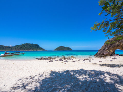 LIPE Island see Speed boat float in blue sea and mountain with white sand , Satun, Thailand