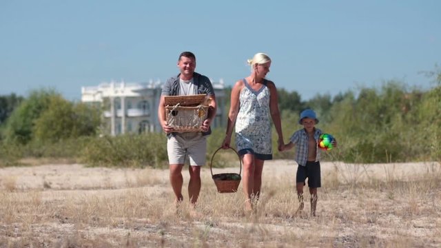 Happy family going on pinic to the beach