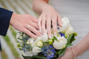 Obraz na płótnie Canvas Newly weding couple showing off their wedding rings.