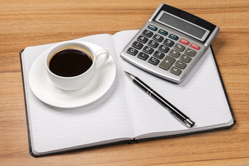 Cup of coffee, notebook, calculator and pen top view