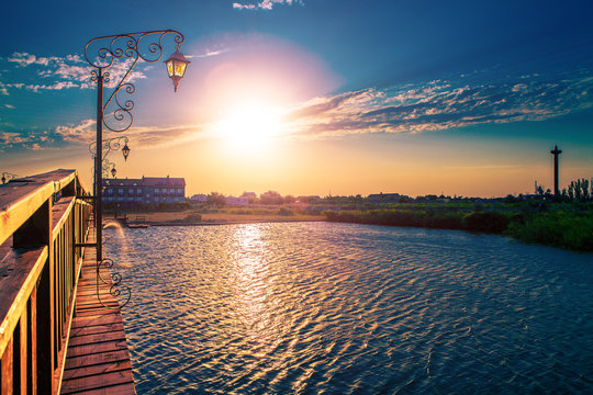 summer sunset on the small river near a bridge © Ruslan Ivantsov