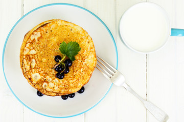 Pancakes with Milk and Currant on White Boards