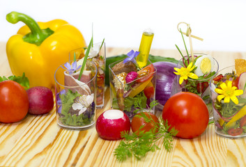 mini canapes in plastic cups decorated with edible flowers