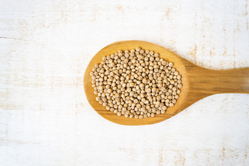 Giant wholegrain couscous in wooden spoon