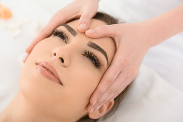 Carefree woman enjoying treatment at spa